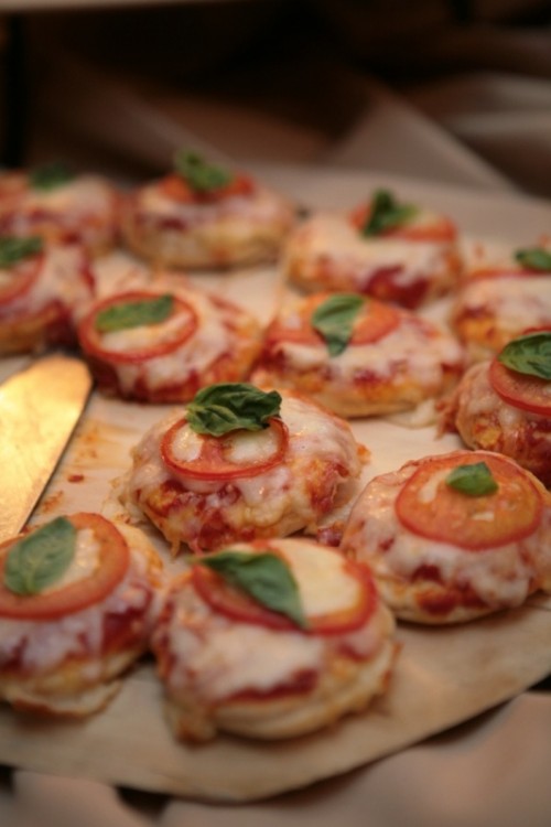 a mini pizza table with a tray for serving little bites