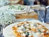 a rustic pizza bar with crates as pizza stands and some baby’s breath is a very simple and cool idea