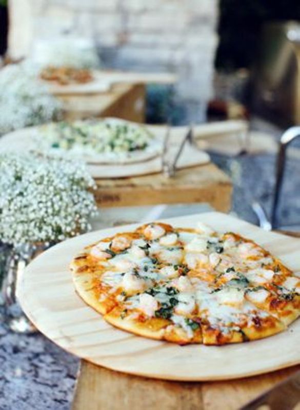 a rustic pizza bar with crates as pizza stands and some baby's breath is a very simple and cool idea