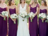 super bold purple maxi bridesmaid dresses with mismatching necklines, draped and tied bodices and pleated skirts are wow