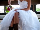 a strapless princess-style wedding dress with a draped and embellished bodice and a full skirt, brown cowboy boots is an amazing idea to rock