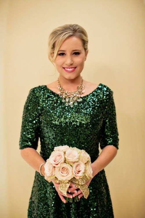 a green sequin bridesmaid dress with a scoop neckline and short sleeves, a statement necklace, blush blooms and a gold glitter wrap