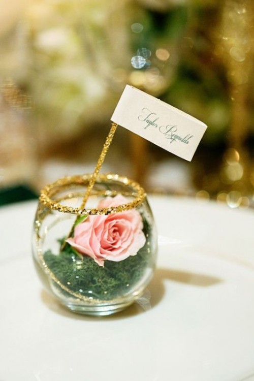 a glass with moss, gold glitter rim, a pink bloom and a topper is a lovely idea for a wedding, it can be part of your centerpiece