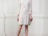 a pretty retro-inspired embellished wedding dress with bell sleeves, a high neckline and metallic accessories for a glam look