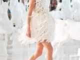 a sleeveless mini dress with feathers all over it plus high white heels for an ultra-modern and super bold look
