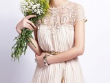 a nude A-line mini dress with a fully embellished neckline and cap sleeves and a pleated dress itself
