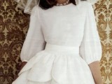a creative mini wedding dress with a bodice and puff sleeves, a high neckline and a whimsical full scallop layer skirt