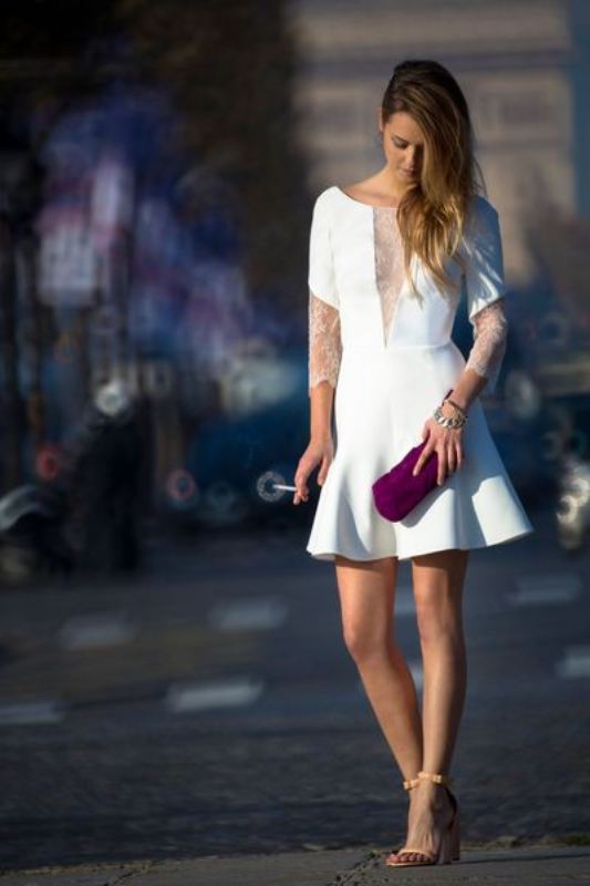 A statement a line plain mini wedding dress with lace sleeves and a plunging neckline covered with lace, nude heels and a fuchsia clutch for a bold look