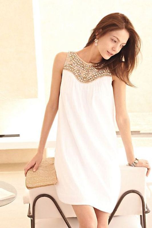 A pretty A line mini dress with a fully embellished neckline looks glam and folksy at the same time