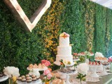 a living wall is a lovely wedding backdrop idea not only for a ceremony but also for a reception or even a dessert table