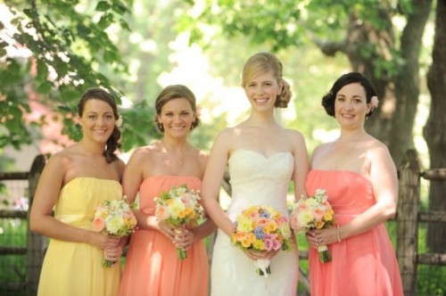 mismatching salmon pink and yellow strapless bridesmaid dresses are great for a bright spring or summer wedding