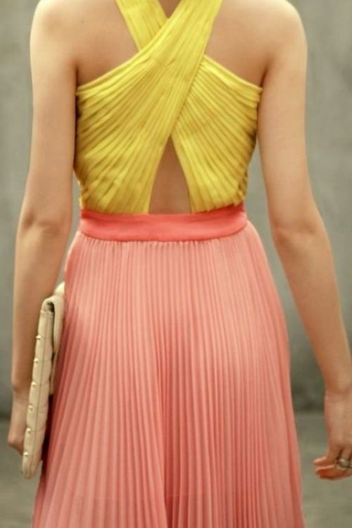 dress your bridesmaids in yellow criss cross tops and salmon pink pleated skirts for a bold and catchy look