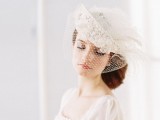 a beautiful vintage bridal hat in white, with a birdcage veil, rhinestones, pearls and feathers is amazing