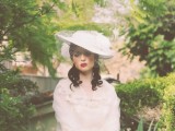 a vintage white hat with a birdcage veil and feathers is a gorgeous accessory for a vintage bride