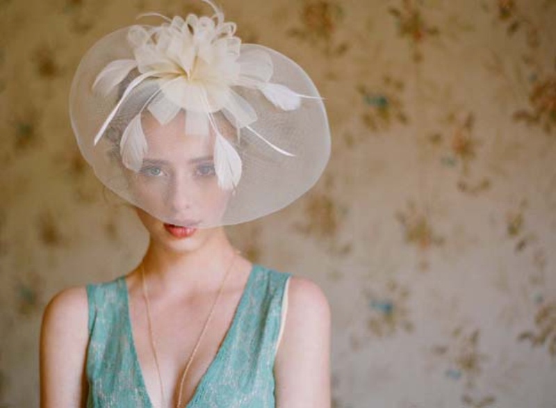A sheer wide brim hat with white petals on top is a gorgeous accessory to rock for a vintage bridal look