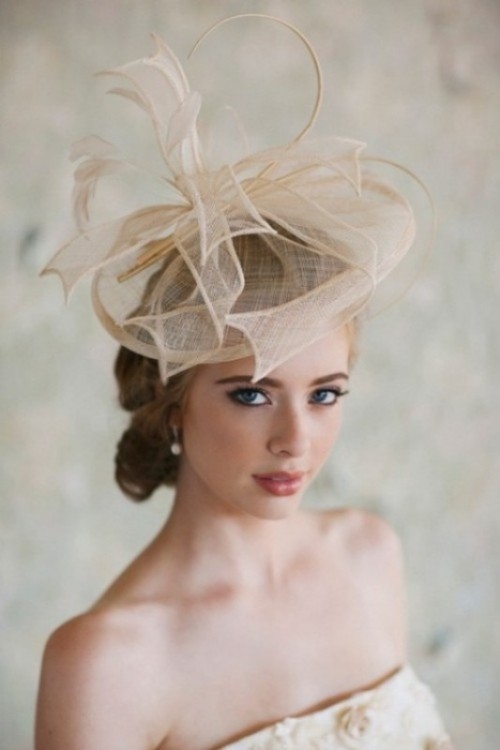 an airy tan semi sheer hat with a large bow on top is a delicate yet rather bold idea for a bride with a vintage feel