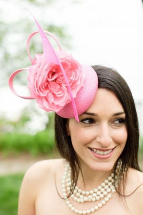 a whimsical pink hat with a large bloom and ribbon is a catchy and bold idea for a bride who loves vintage, horse races and bold colors