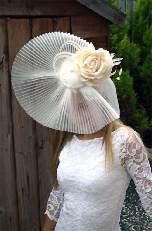 a sheer wide-brim hat with a large fabric bloom on top is a lovely and catchy idea for a neutral bridal look