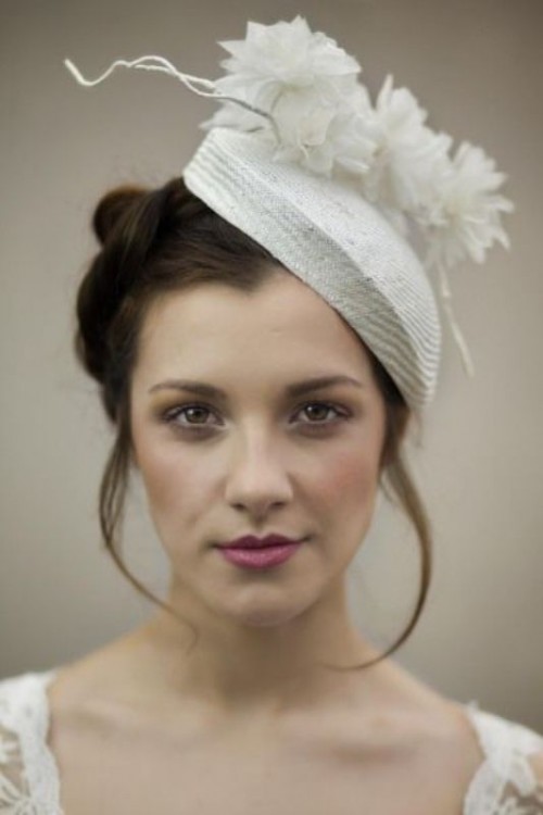 a small and delicate neutral bridal hat with fabric blooms and twigs is a lovely idea for a neutral bridal look