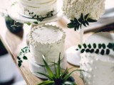 textural small white wedding cakes accented with greenery and leaves for a modern or minimalist wedding