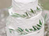 a textural white wedding cake with olive greenery is ideal for a Tuscany wedding
