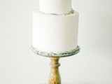 a textural white wedding cake with some greenery on top is a stylish and simple idea to rock