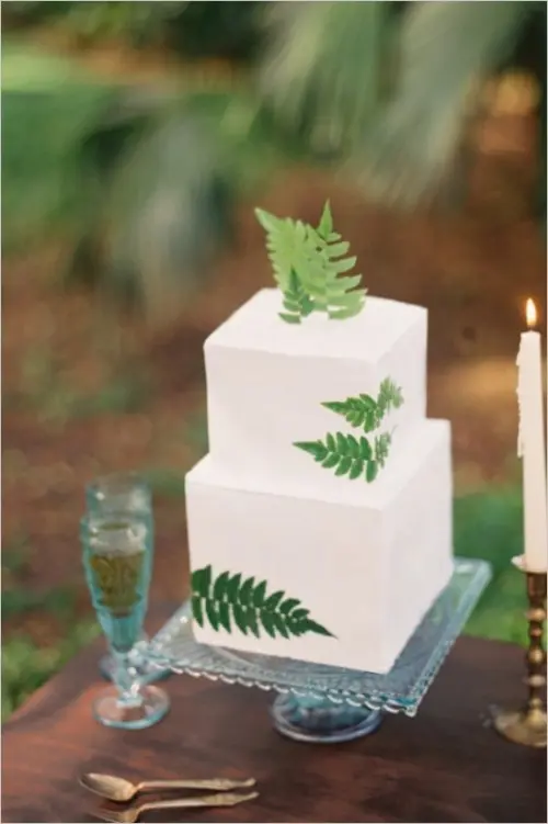 a modern woodland square wedding cake with fresh fern leaves is an amazing dessert with impeccable taste