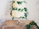 a tan textural wedding cake decorated with foliage and neutral berries is a chic idea for a garden wedding