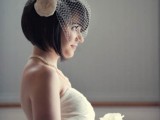 a short black pixie with a fringe and a vintage-inspired birdcage veil with a faux bloom is a chic and lovely idea for a vintage bride