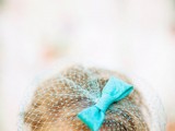 a long blonde pixie with a bold blue birdcage veil with a bow is an eye-catchy retro or vintage inspired look