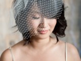 a long black wavy bob with a delicate white birdcage veil is a lovely idea for a modern bride