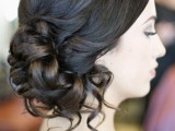 a curly side updo with a sleek top is a stylish idea for a bride who wants a bit of vintage chic