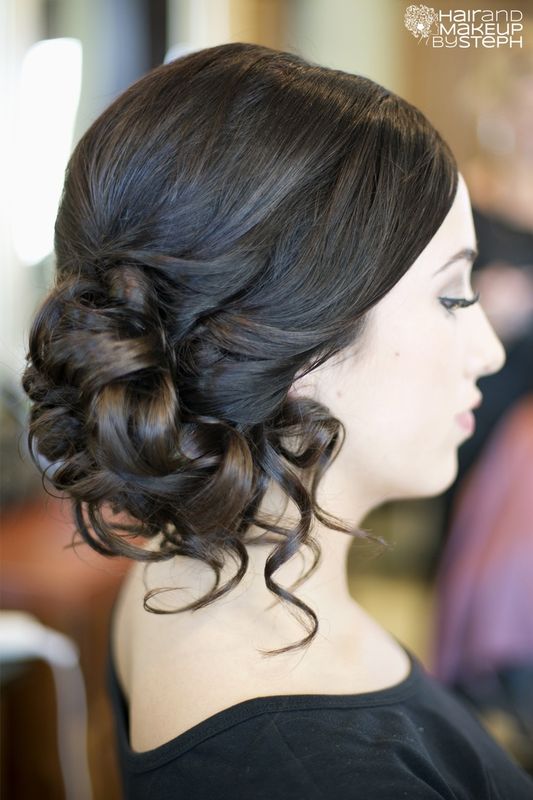 A curly side updo with a sleek top is a stylish idea for a bride who wants a bit of vintage chic