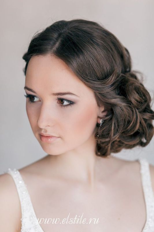 A super elegant curly side updo with a volume on top is a chic hairstyle that wows