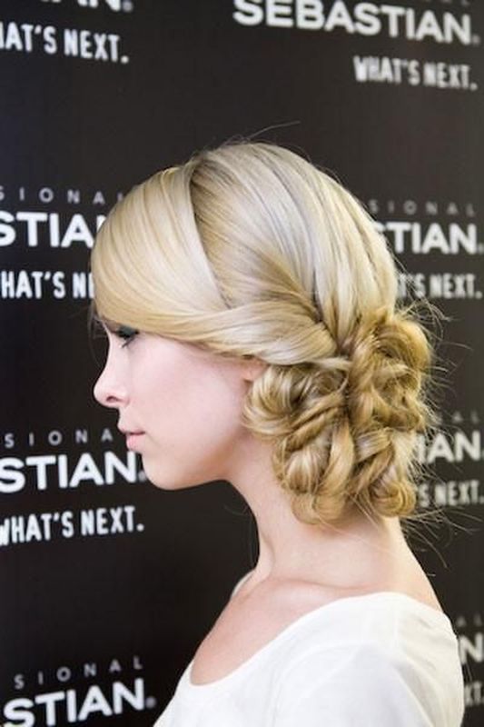 A fully braided side updo with a textural top is a stylish idea for braid loving brides