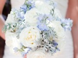 a white and powder blue wedding bouquet with a touch of greenery looks heavenly, chic and stylish
