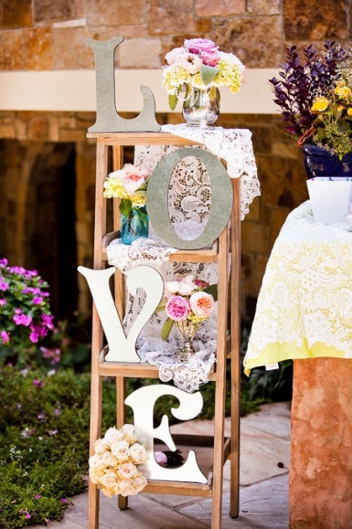 a vintage easel with LOVE letters, fresh blooms and lace for a vintage tea party shower