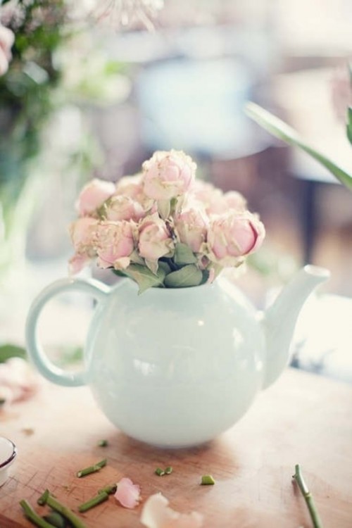 a vintage bridal shower centerpiece of a mint tea pot with pastel blooms