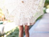 a lace parasol is a fun favor and decor idea for a vintage tea party shower