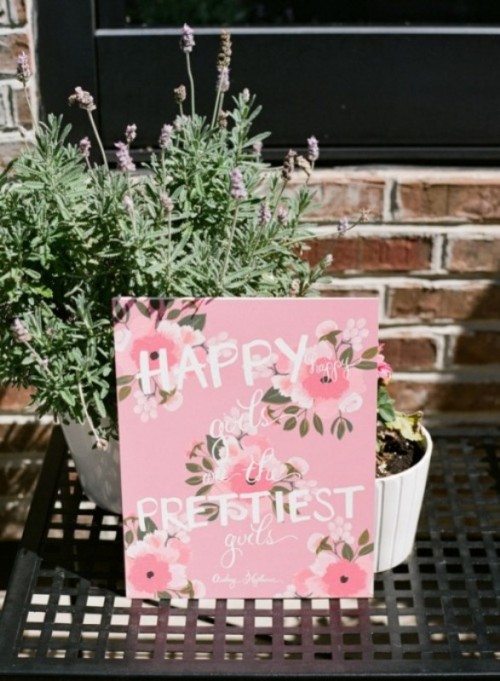 a pink floral sign is a fun and easy decor idea for a tea party bridal shower