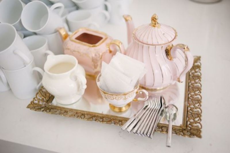 a glam vintage tea party setting with vintage porcelain and a mirror tray