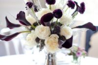 a contrasting winter wedding centerpiece of white blooms, herbs and deep purple flowers