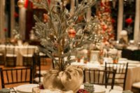 a homey winter wedding centerpiece of a box and a mini Christmas tree on it – withh pinecones and ornaments