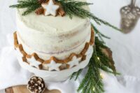 a naked wedding cake topped and covered with gingerbread glazed cookies, cinnamon bark, evergreens and other stuff is a lovely idea