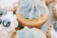 cool tartlets with icy blue topping and blueberries are a delicious idea for a Frozen-inspired wedding