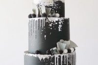 a bold modern wedding cake in black and white, with drip, blackberries, shards and a sugar bow on top