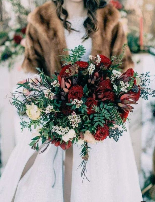 a bold red winter wedding bouquet with greenery, privet berries, greenery and white blooms