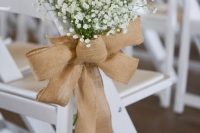 a burlap bow with baby’s breath is a stylish wedding decor idea, it will give a rustic feel to the space