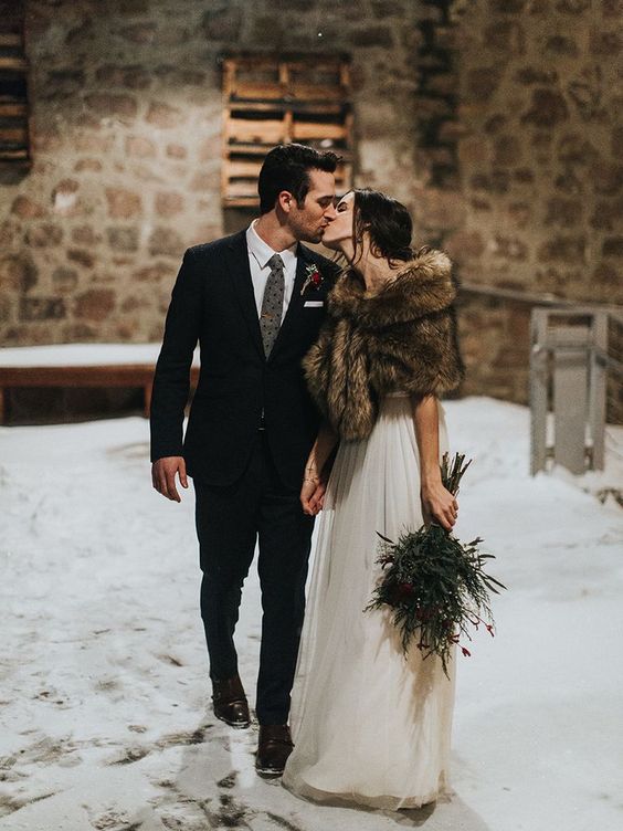 a chic bridal look with an A-line wedding dress and a brown faux fur cover up is a gorgeous idea for fall or winter