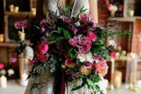 a colorful and lush winter wedding bouquet in pink, purple, withmuch greenery and texture